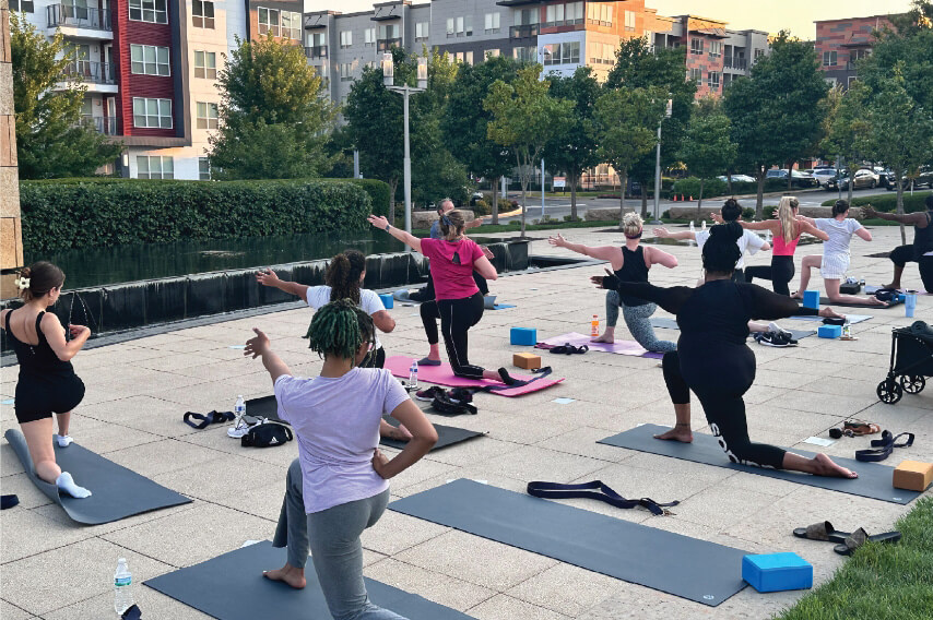 Yoga class taking place in an outdoor plaza