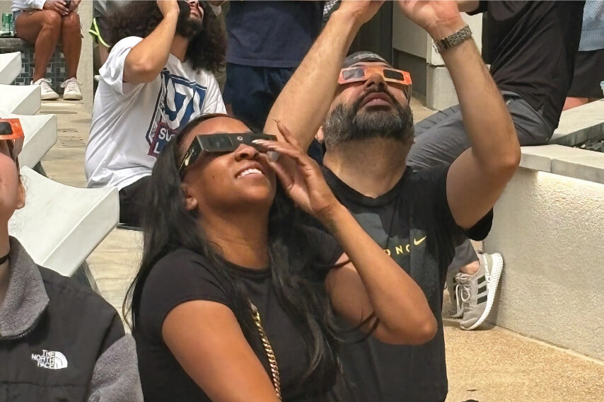People watching the sky wearing eclipse glasses